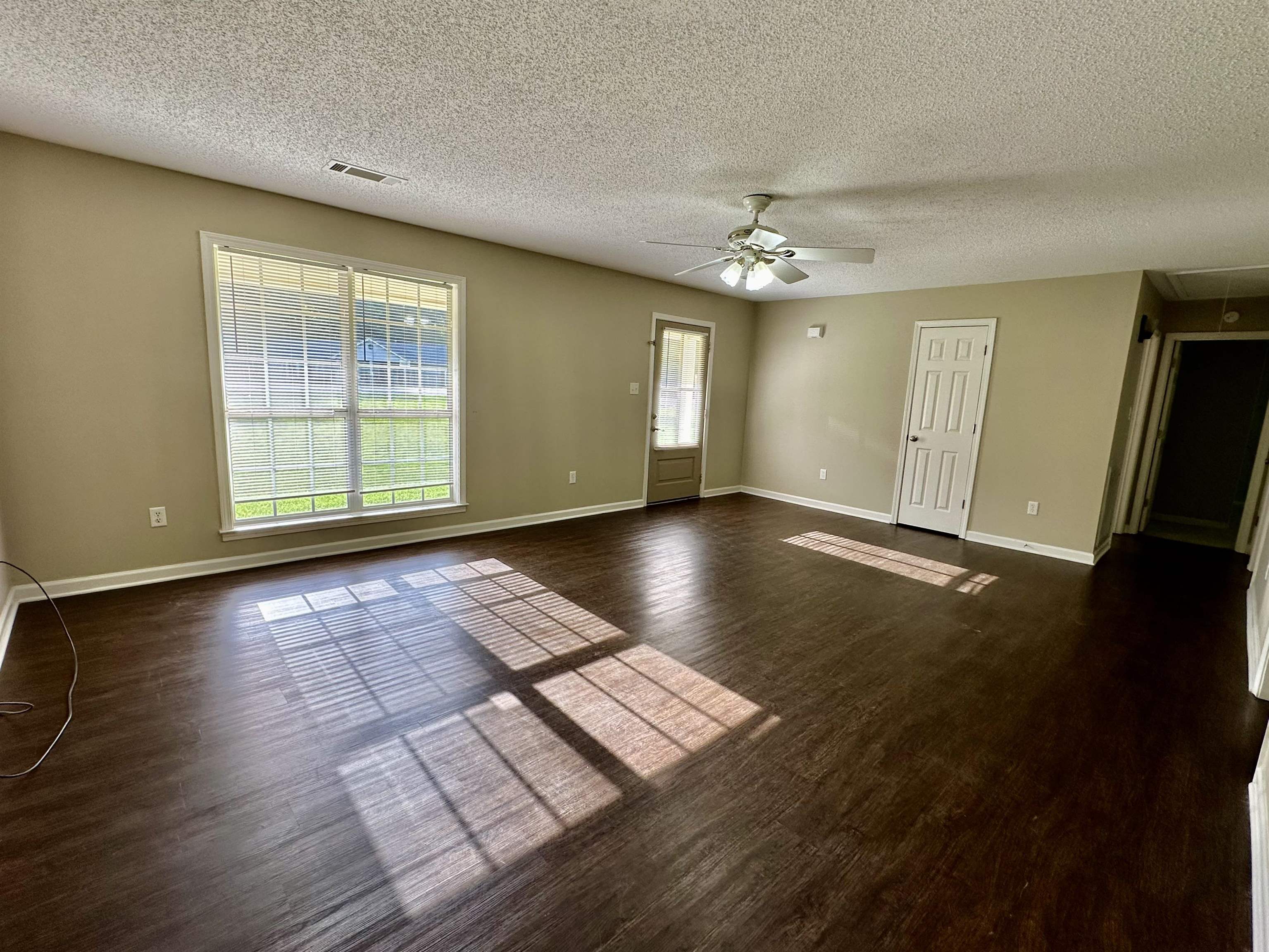 3536 Ray Bluff Road Millington, TN 38053 - Photo 3 of 17 a view of an empty room with window and wooden floor