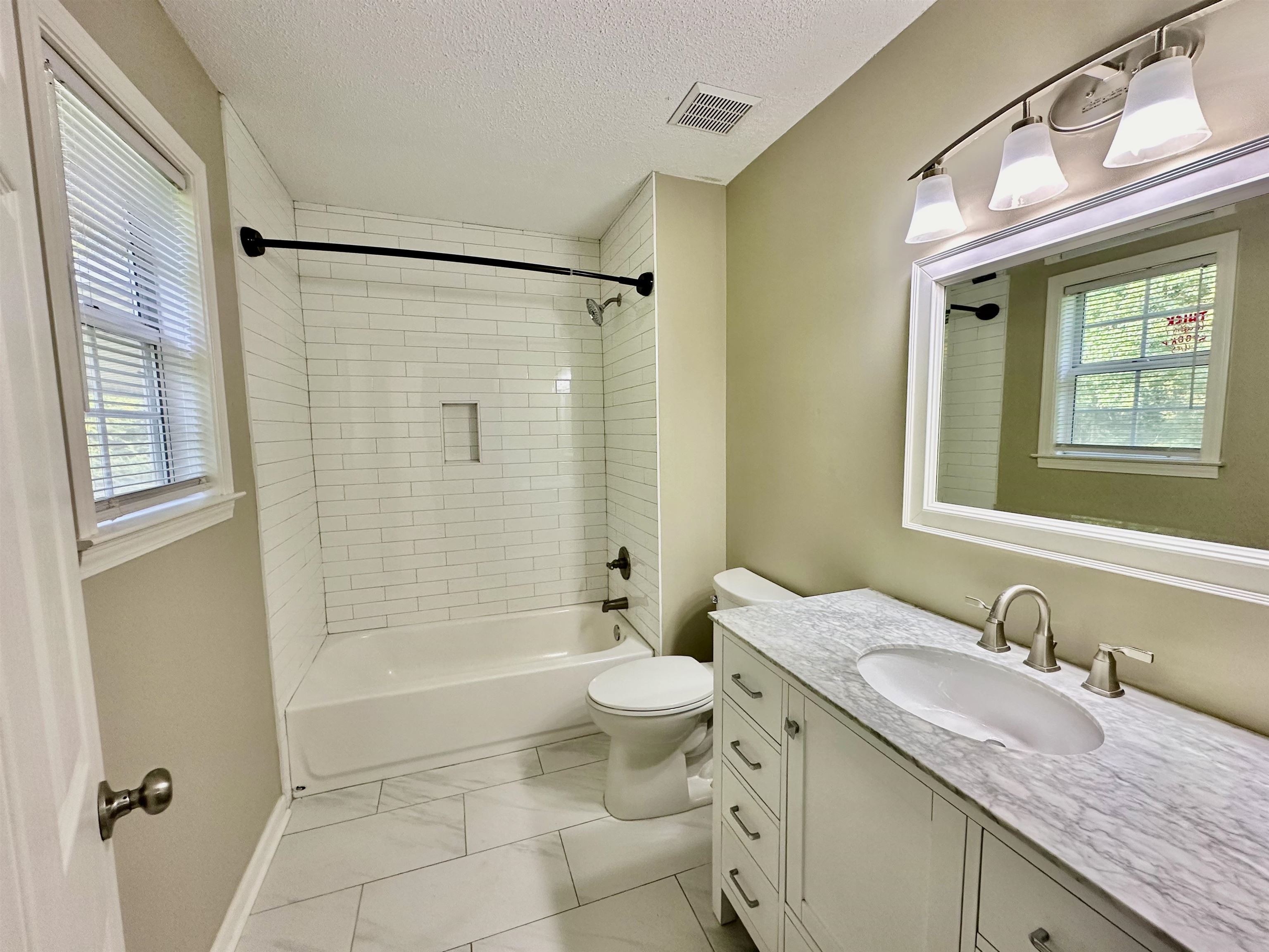 3536 Ray Bluff Road Millington, TN 38053 - Photo 10 of 17 a bathroom with a granite countertop sink a toilet and shower