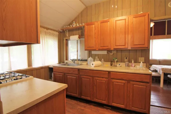 a kitchen with a sink cabinets and window