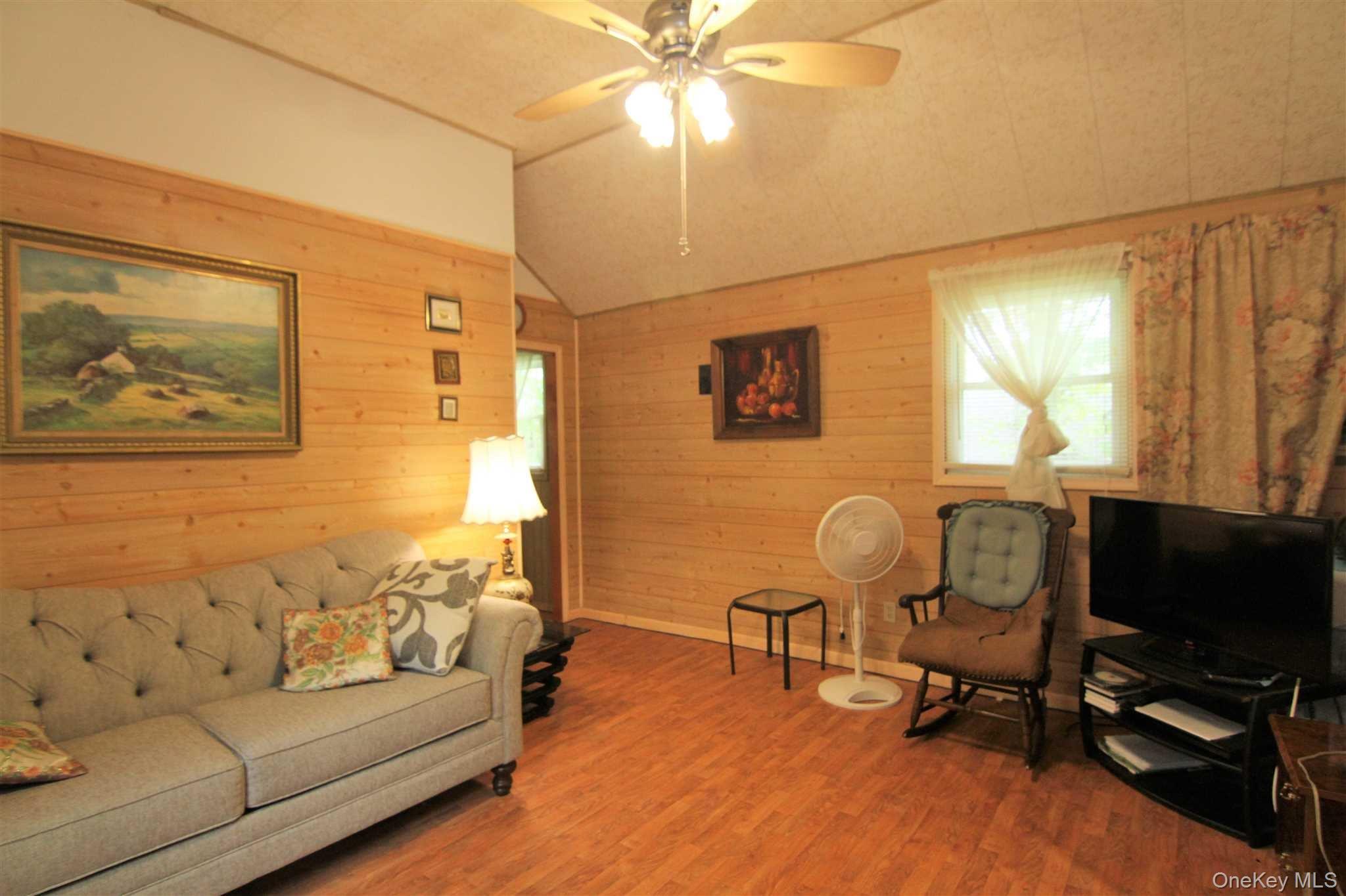 50 Glanhope Road, Unit 23 Hopewell Junction, NY 12533 - Photo 18 of 33 a living room with furniture and a flat screen tv