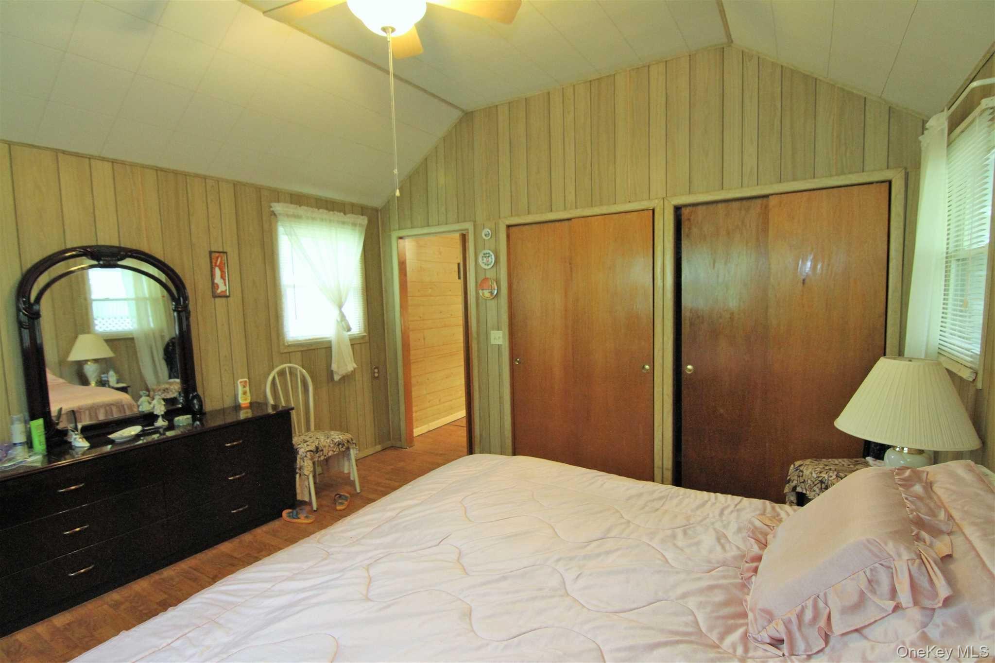 50 Glanhope Road, Unit 23 Hopewell Junction, NY 12533 - Photo 21 of 33 a bedroom with a bed and a dresser with mirror