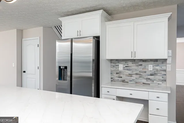 a kitchen with stainless steel appliances granite countertop a sink a stove and cabinets
