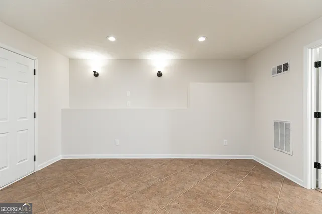 a view of backyard with wooden fence and trees