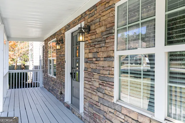 a view of a hallway with wooden floors and stairs