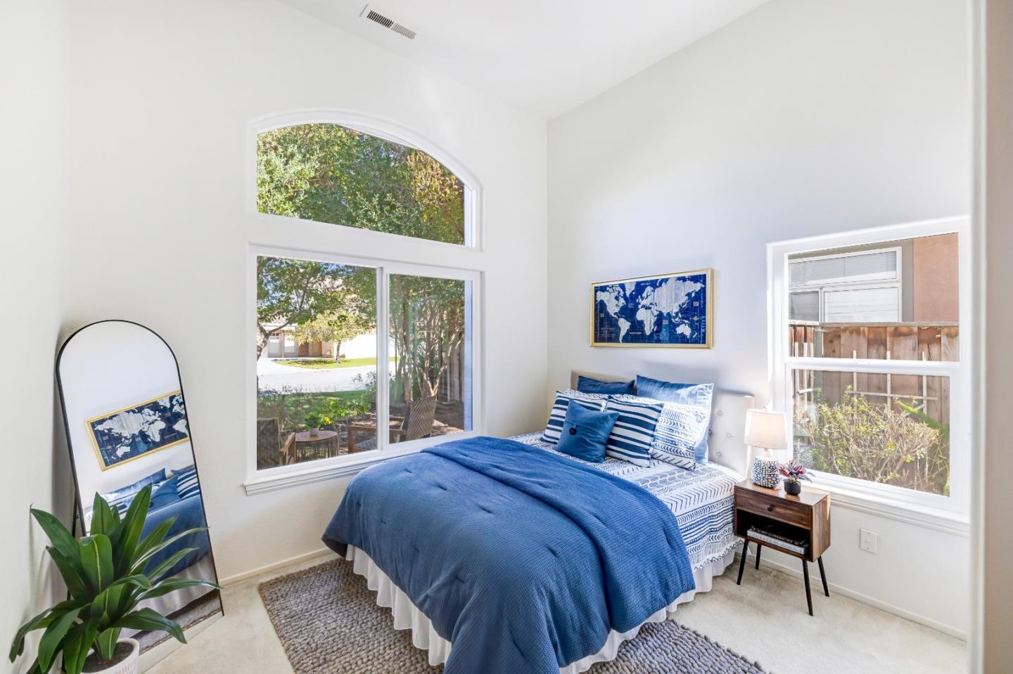 17602 Winding Creek Road Salinas, CA 93908 - Photo 12 of 15 a bedroom with a bed and a large window