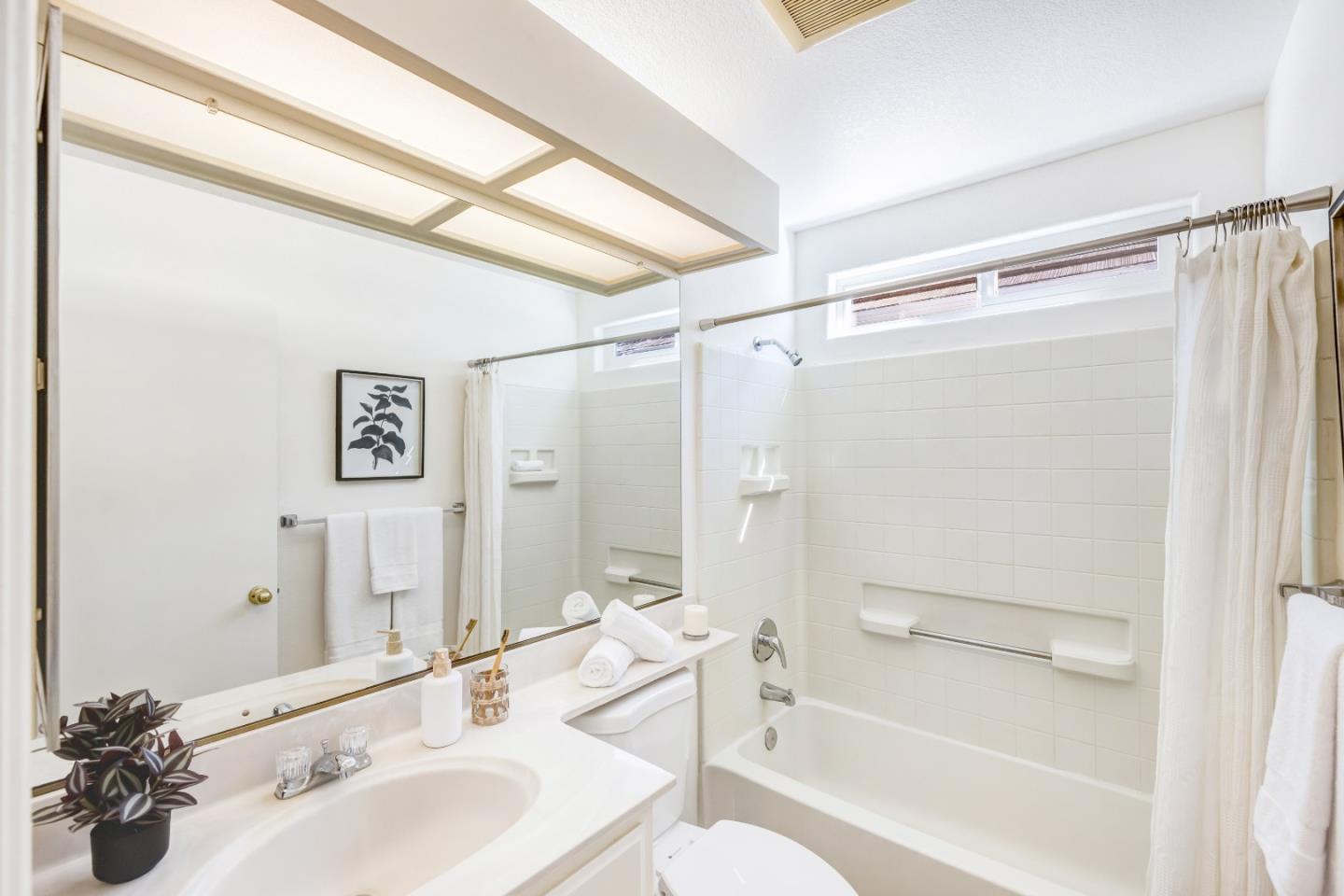 17602 Winding Creek Road Salinas, CA 93908 - Photo 13 of 15 a bathroom with a sink mirror shower and a bathtub