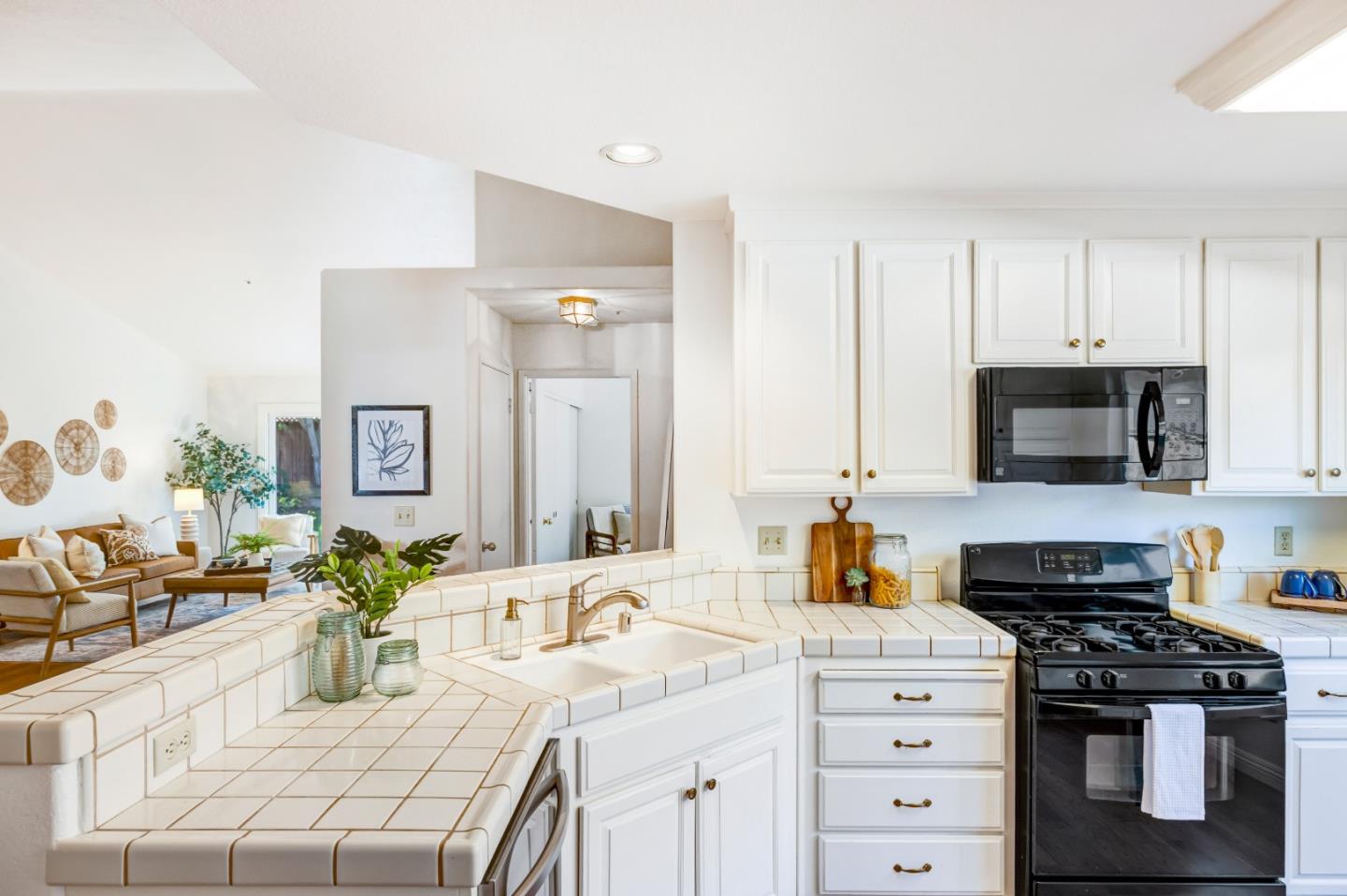 17602 Winding Creek Road Salinas, CA 93908 - Photo 7 of 15 a kitchen with stainless steel appliances kitchen island granite countertop a sink dishwasher stove and white cabinets