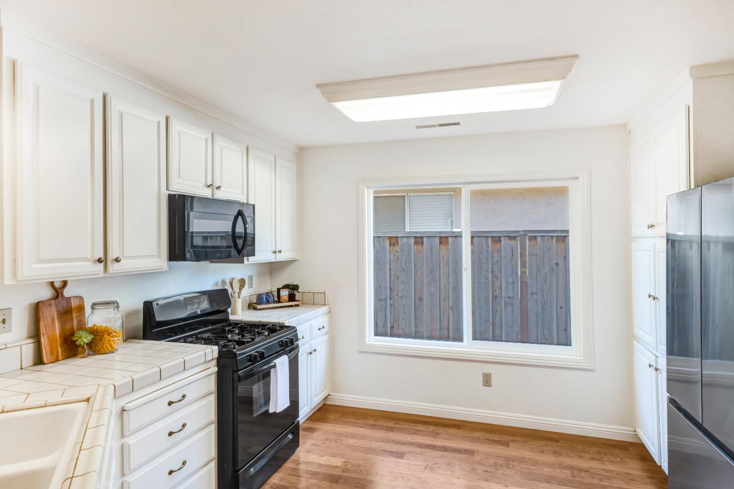 17602 Winding Creek Road Salinas, CA 93908 - Photo 8 of 15 a kitchen with stainless steel appliances granite countertop a stove a sink and a refrigerator