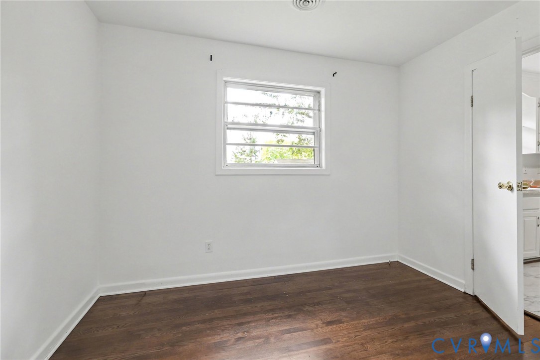 7213 Bennington Road Richmond, VA 23225 - Photo 9 of 24 Dark wood-finish flooring with white baseboards, a