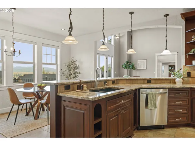 a kitchen with granite countertop stainless steel appliances and cabinets