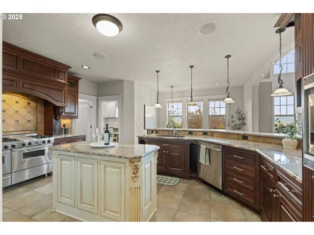 a kitchen with granite countertop a sink a window and cabinets