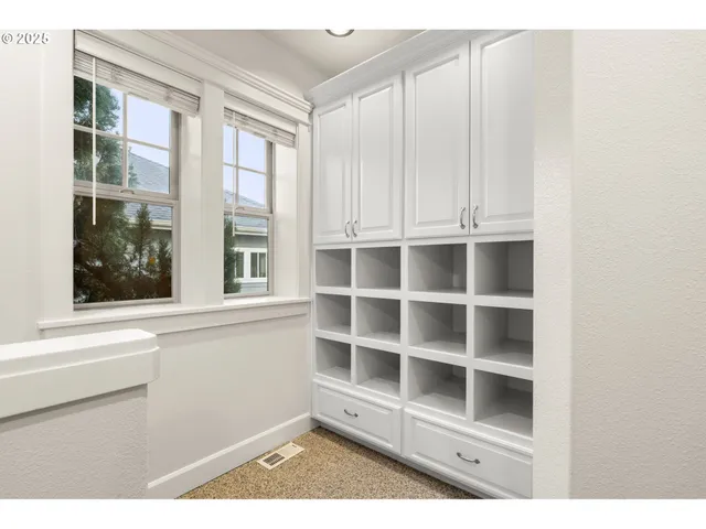 a living room with furniture and a floor to ceiling window