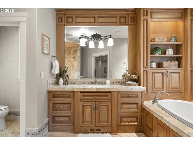 a bathroom with a granite countertop shower a sink and a mirror