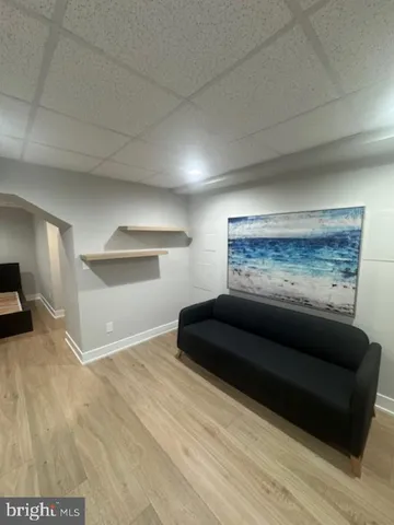 a living room with furniture and a ceiling fan