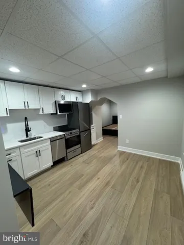 a large kitchen with stainless steel appliances granite countertop a stove a sink and a refrigerator