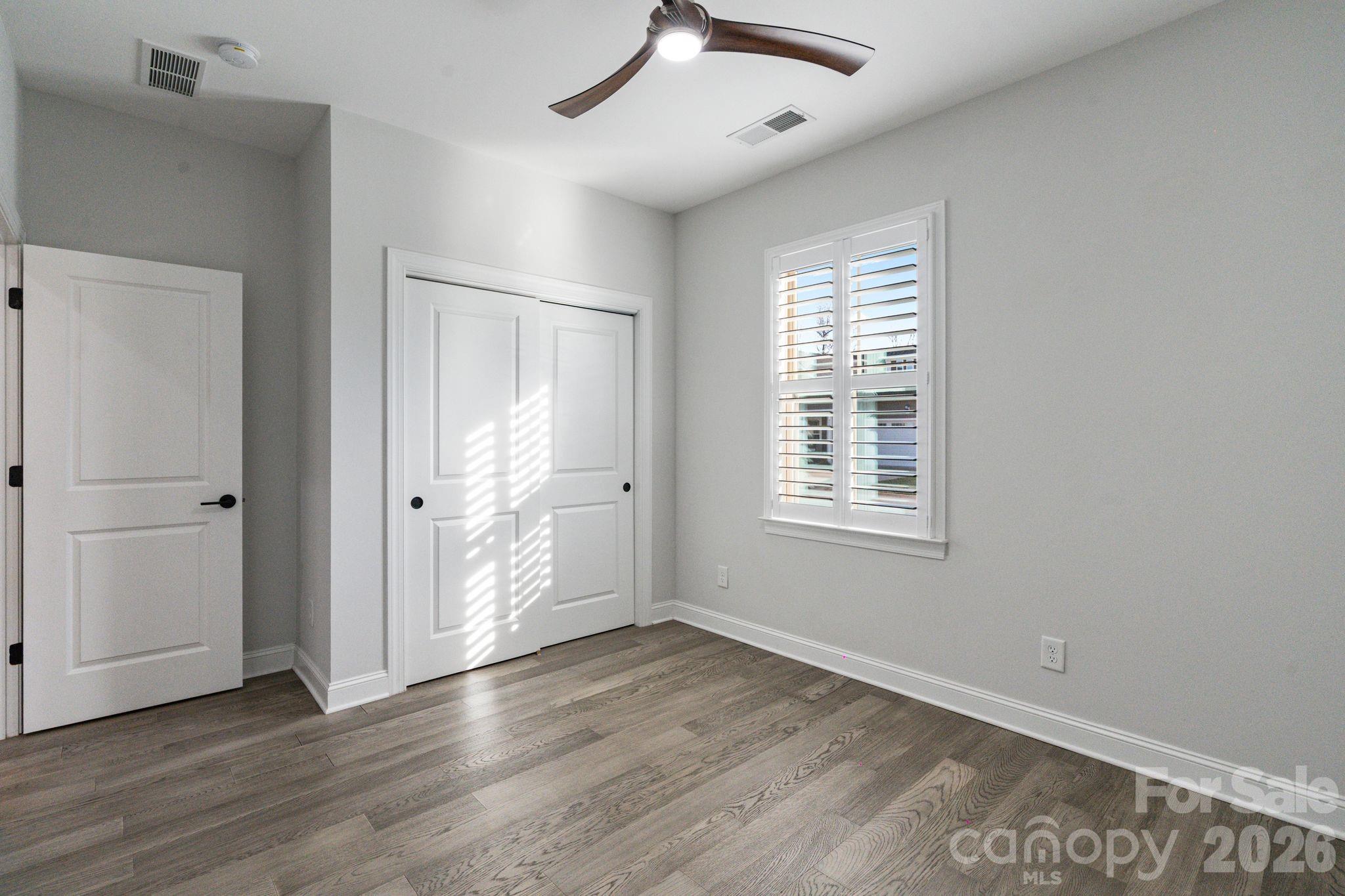 4995 Looking Glass Trail Denver, NC 28037 - Photo 11 of 46 a view of an empty room with wooden floor and a window