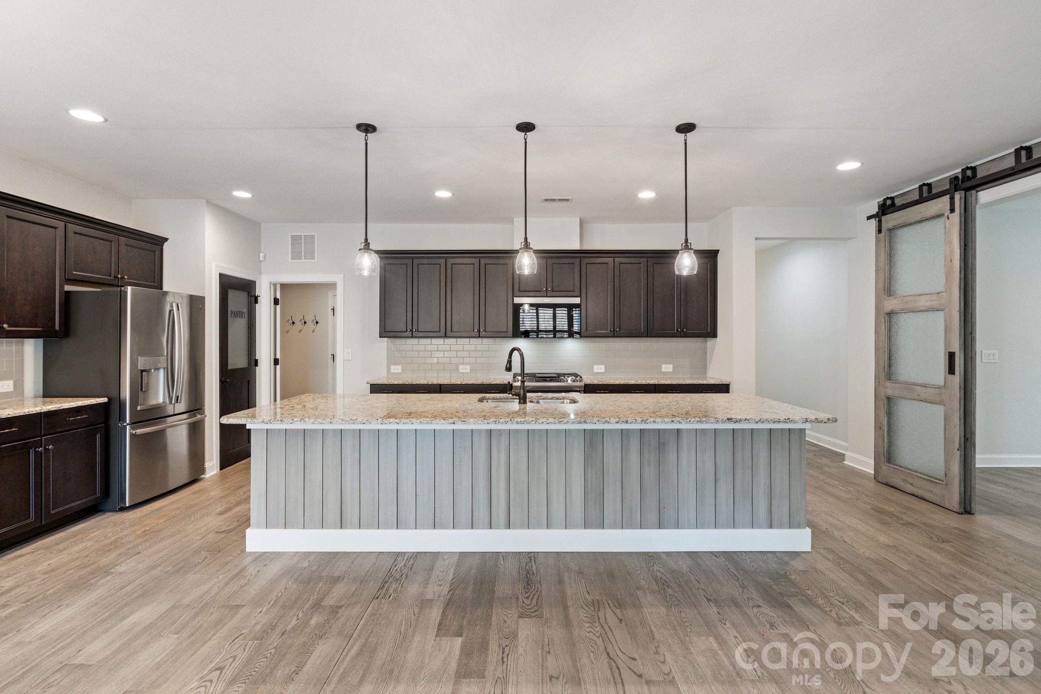 4995 Looking Glass Trail Denver, NC 28037 - Photo 12 of 46 a large kitchen with kitchen island a large island in the center