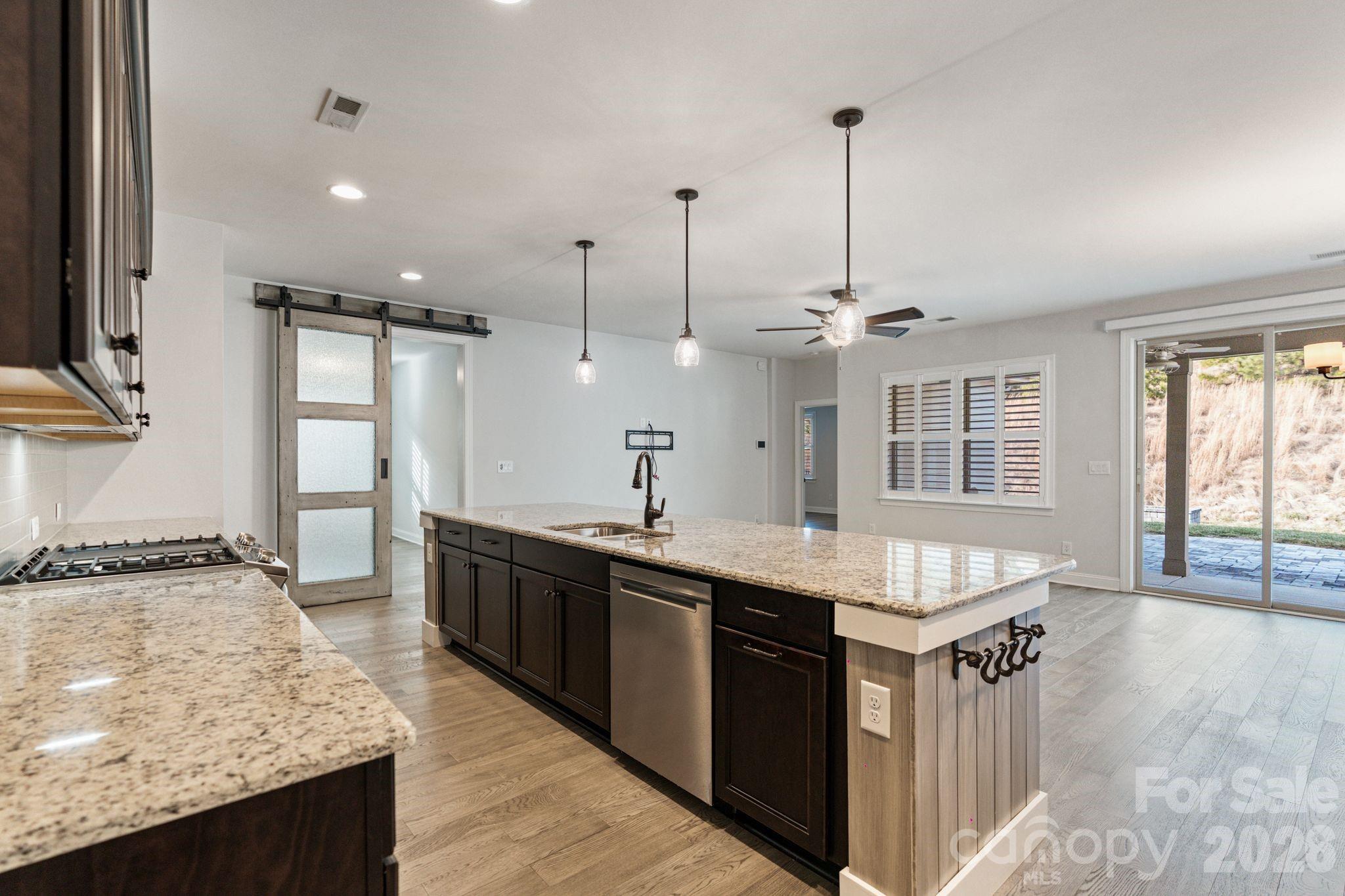 4995 Looking Glass Trail Denver, NC 28037 - Photo 16 of 46 a kitchen with kitchen island granite countertop a sink and a stove