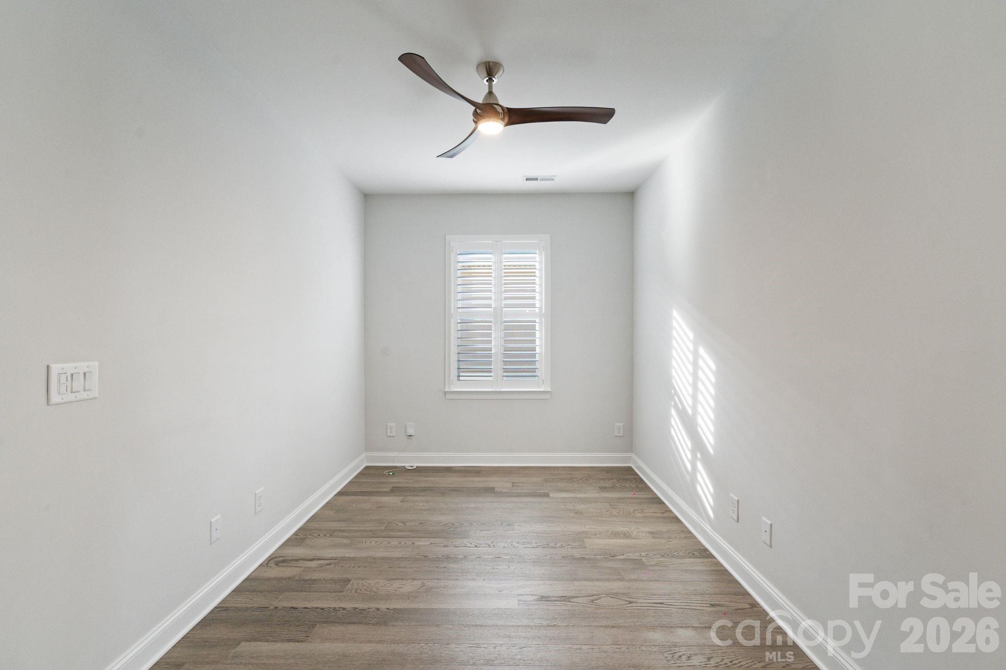 4995 Looking Glass Trail Denver, NC 28037 - Photo 22 of 46 a view of empty room with wooden floor and fan