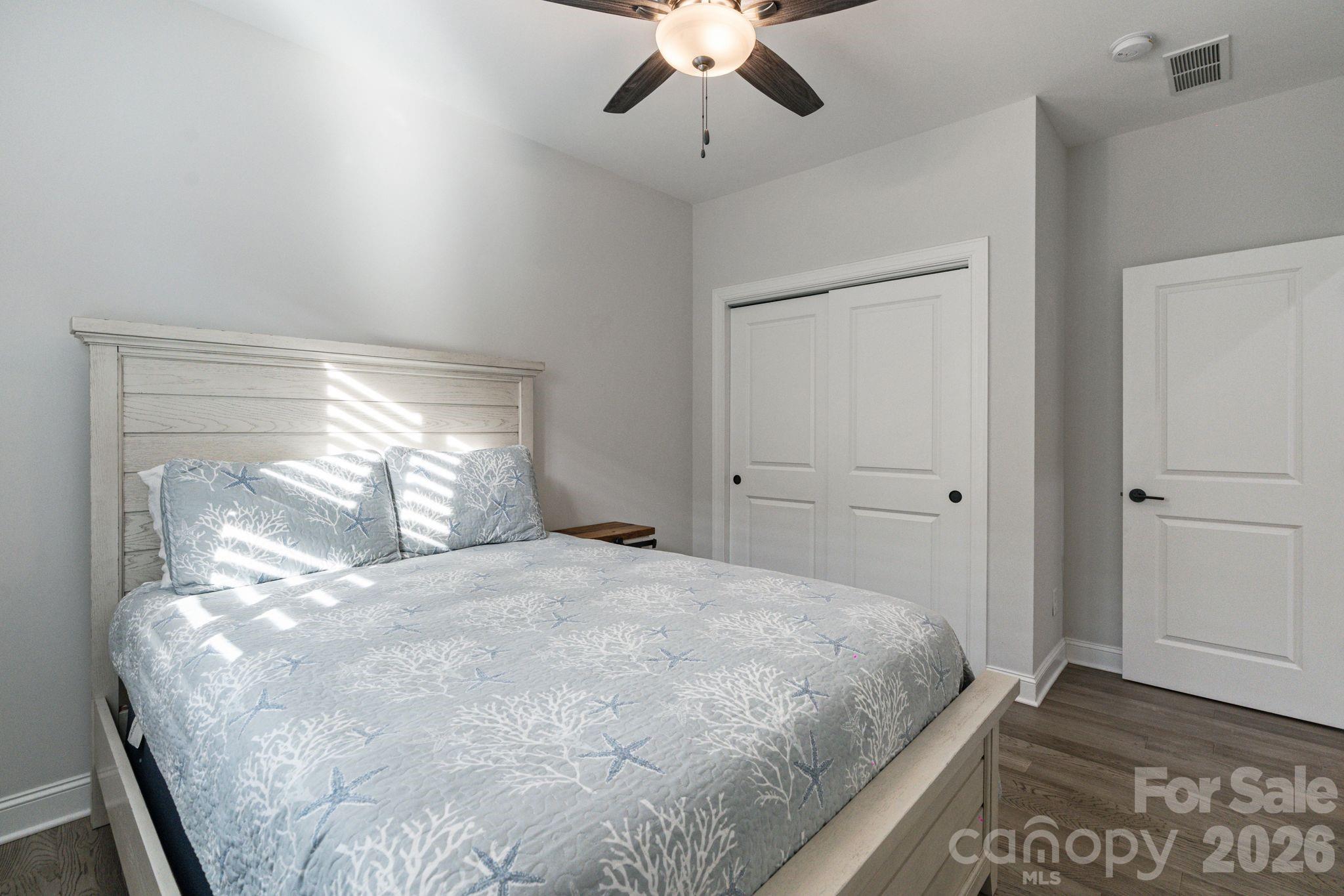 4995 Looking Glass Trail Denver, NC 28037 - Photo 9 of 46 a bedroom with a large bed and a chandelier