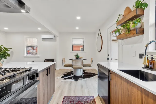a kitchen with a sink appliances and a counter top space