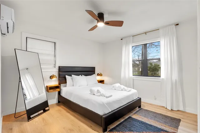a living room with a bed furniture and a window