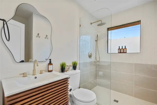 a bathroom with a sink toilet and shower