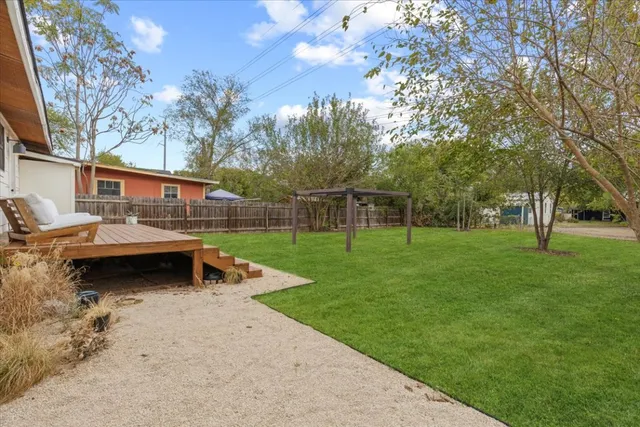 a view of a yard with a house in the background