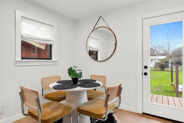 a dining room with furniture and a window