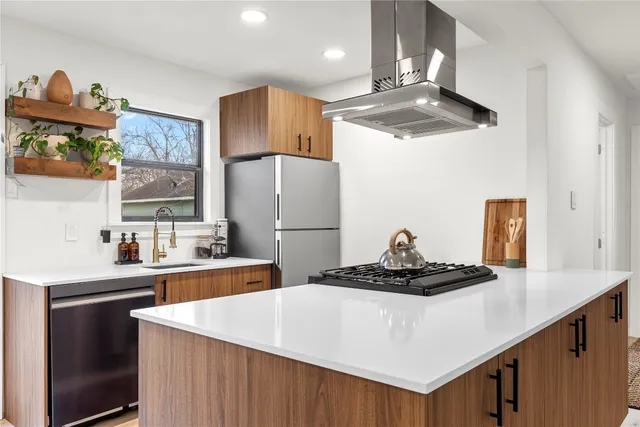 a kitchen with a sink stainless steel appliances and cabinets