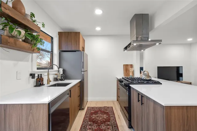 a kitchen that has a sink a stove and a table
