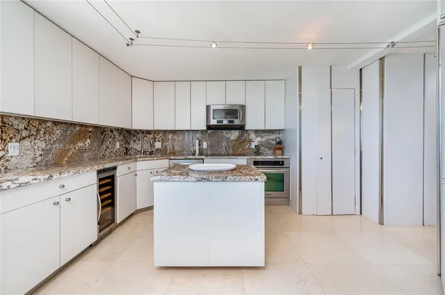 a kitchen with a sink a stove and cabinets