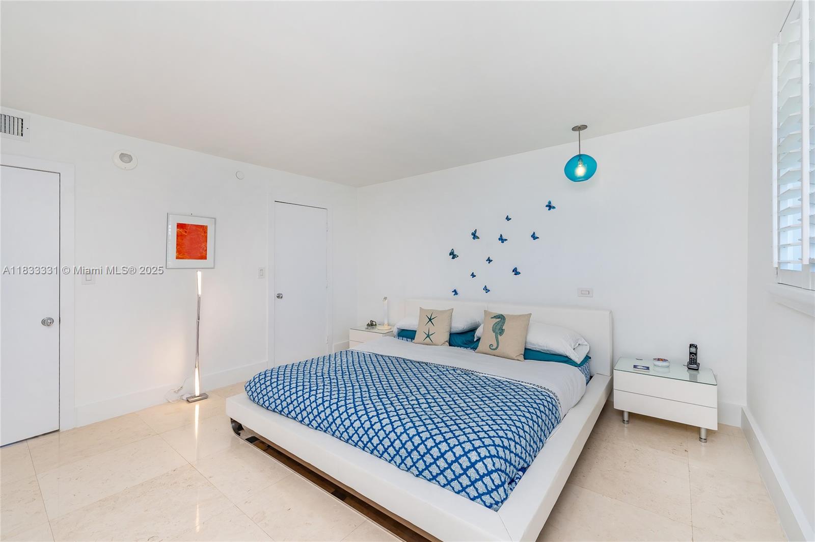 613 Ocean Drive, Unit 7C Key Biscayne, FL 33149 - Photo 19 of 42 a bedroom with a bed and a window