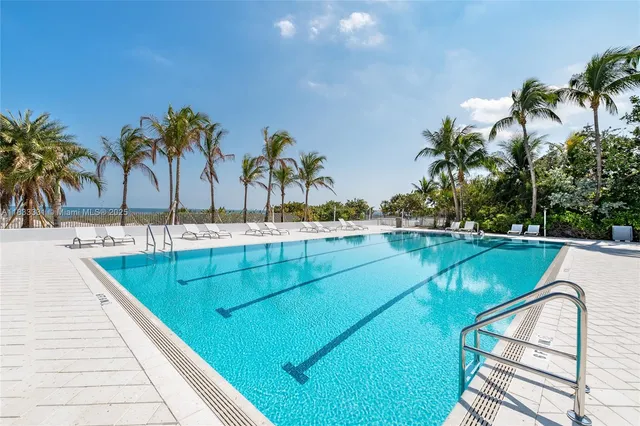 a view of swimming pool with outdoor seating and plants