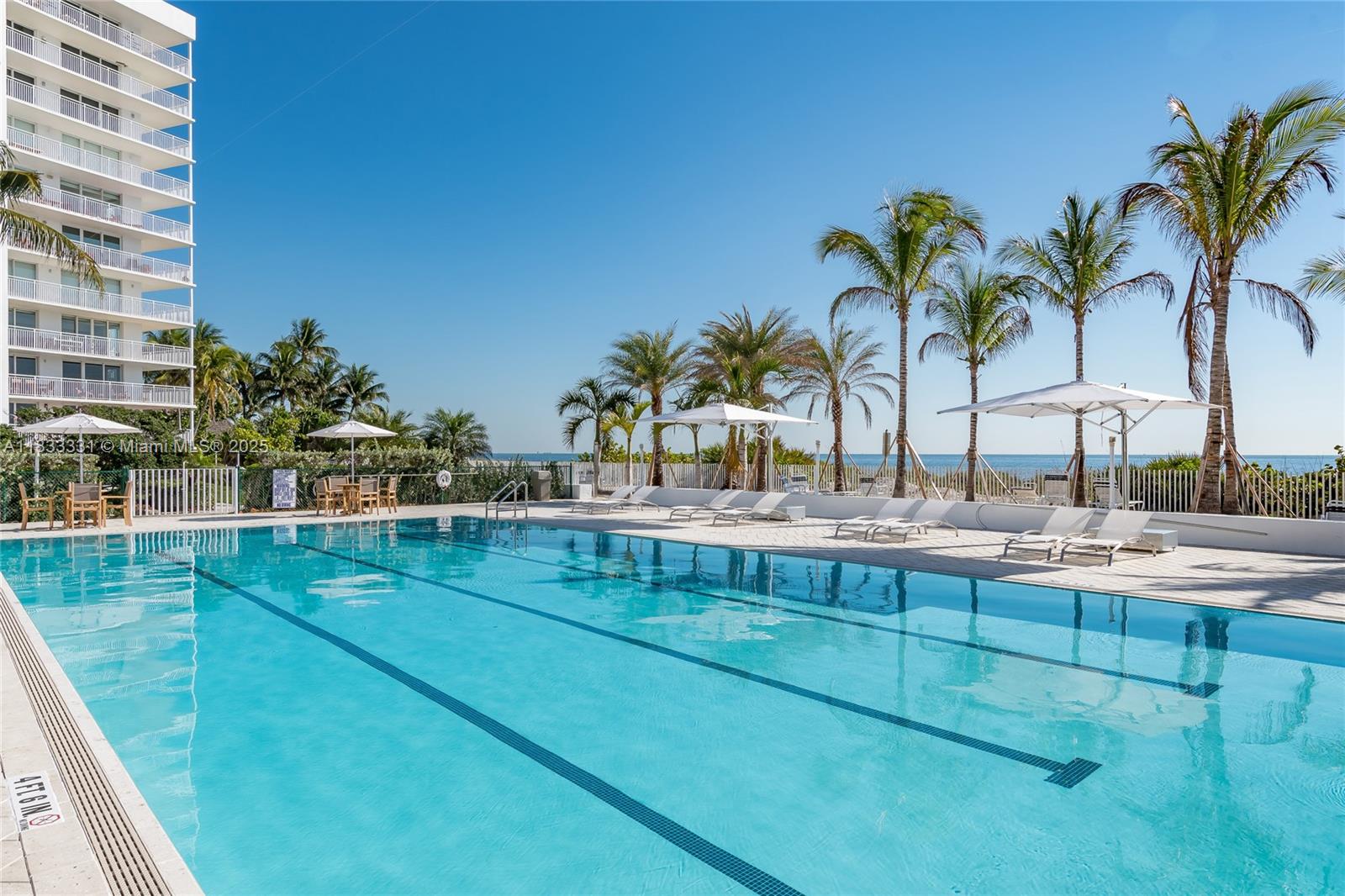 613 Ocean Drive, Unit 7C Key Biscayne, FL 33149 - Photo 28 of 42 a view of swimming pool with outdoor seating and plants