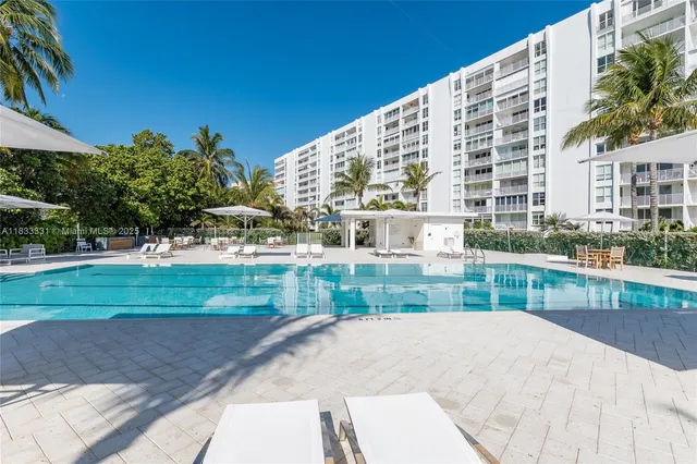 a view of a patio with a table and chairs under an umbrella