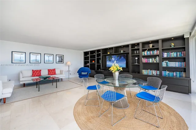 a living room with furniture a wooden floor and white walls
