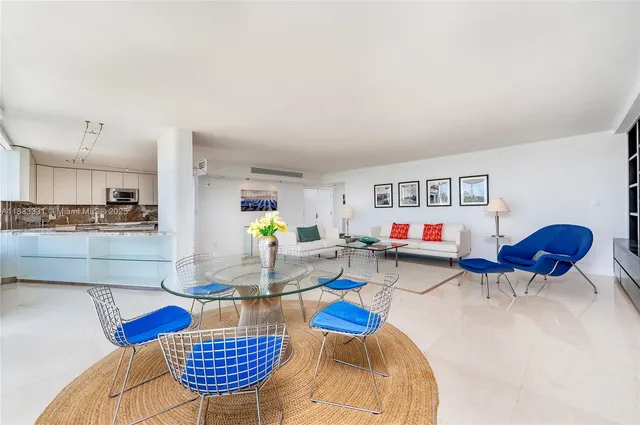 a living room with furniture and kitchen view