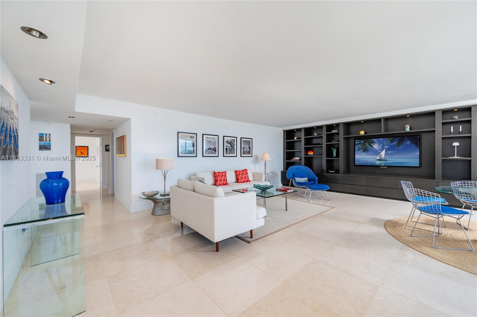 613 Ocean Drive, Unit 7C Key Biscayne, FL 33149 - Photo 10 of 42 a living room with furniture and a flat screen tv