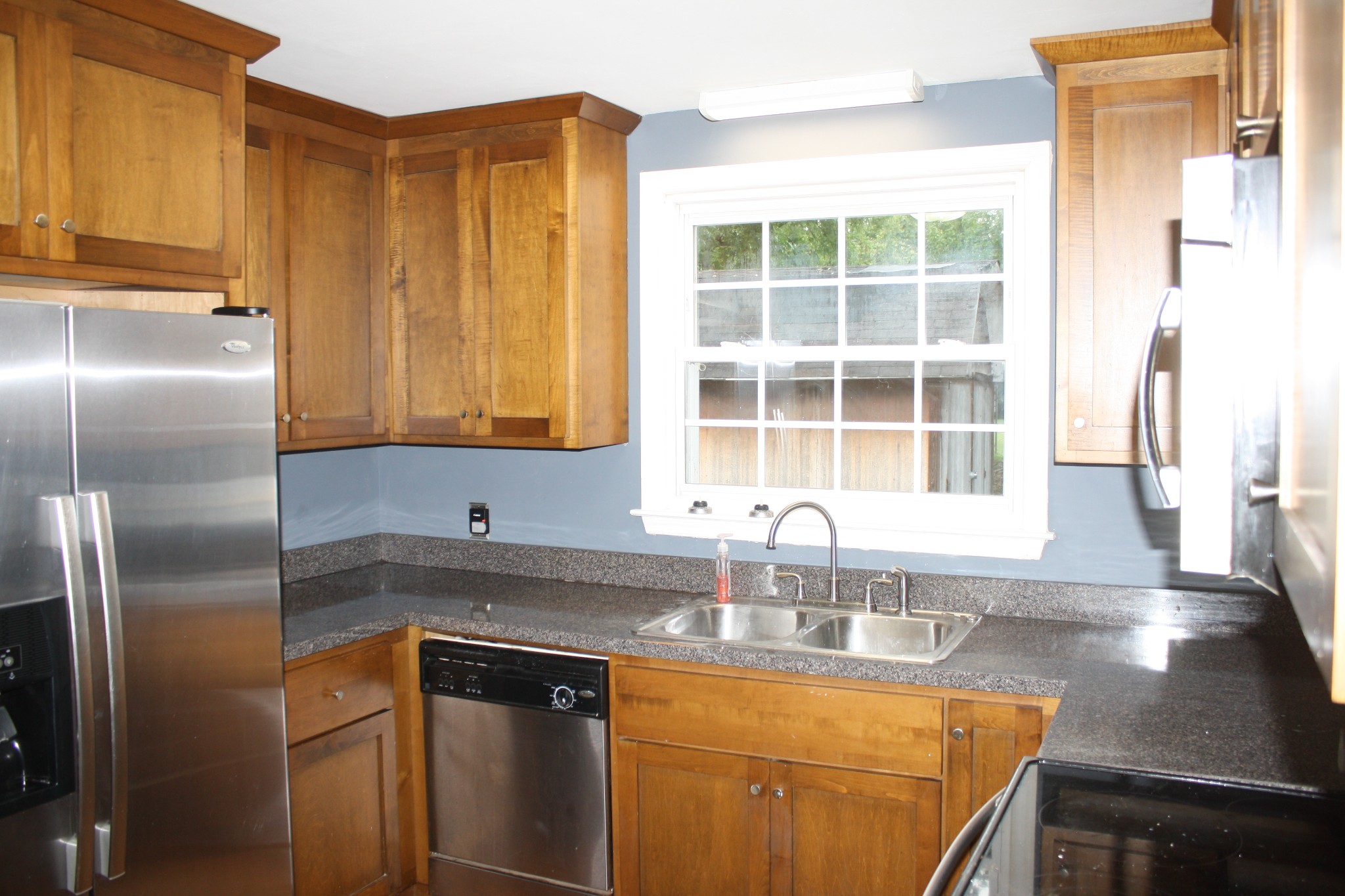 36 Benzing Road Antioch, TN 37013 - Photo 37 of 39 a kitchen with stainless steel appliances granite countertop a sink a refrigerator and a granite counter tops