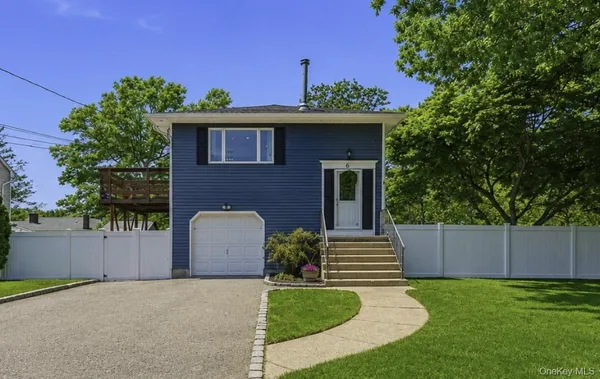 a front view of a house with a yard and a garage