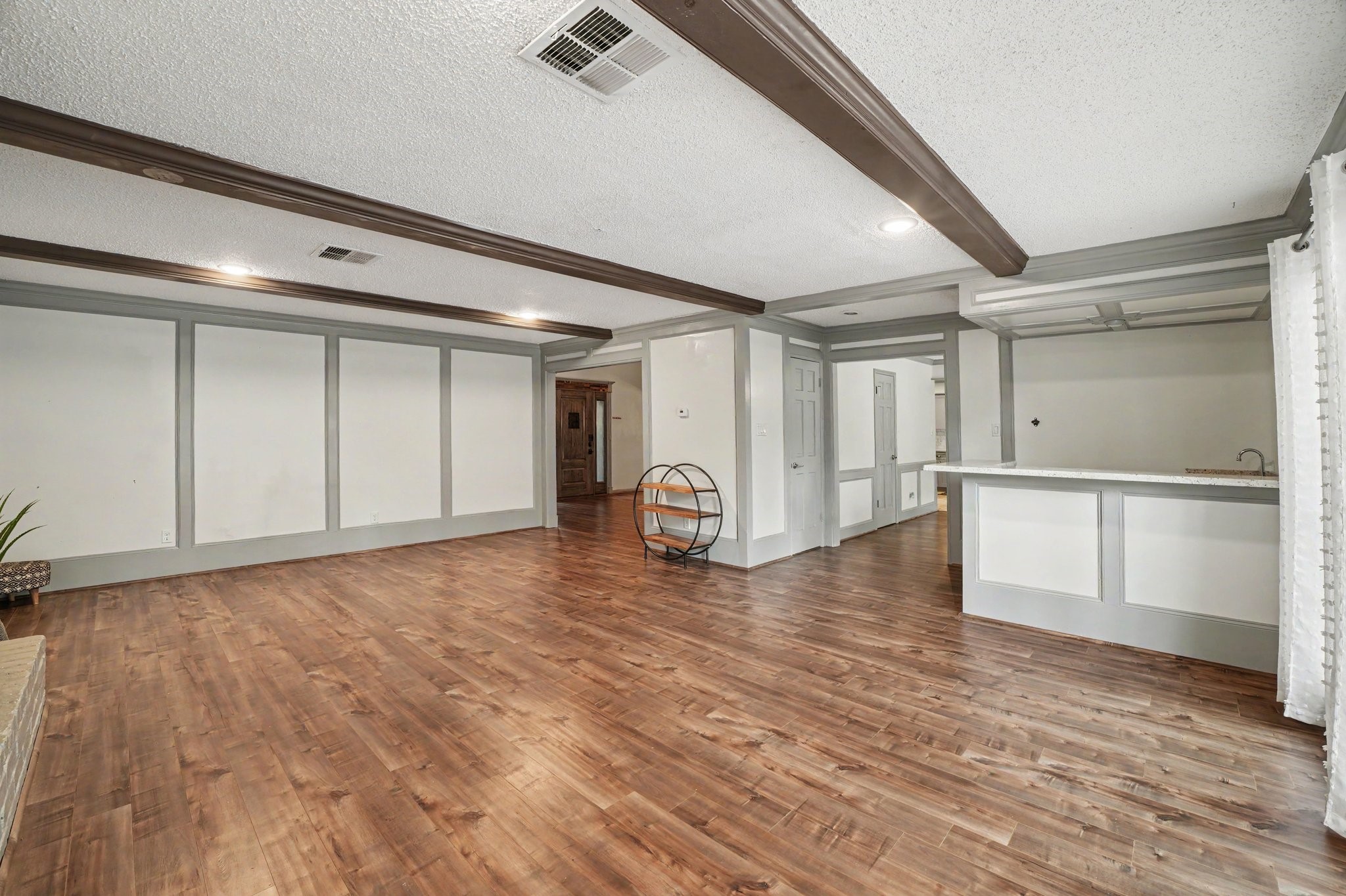 9530 Arcade Drive Spring, TX 77379 - Photo 11 of 32 This living room is enhanced by a wet bar, making it perfect for hosting gatherings.