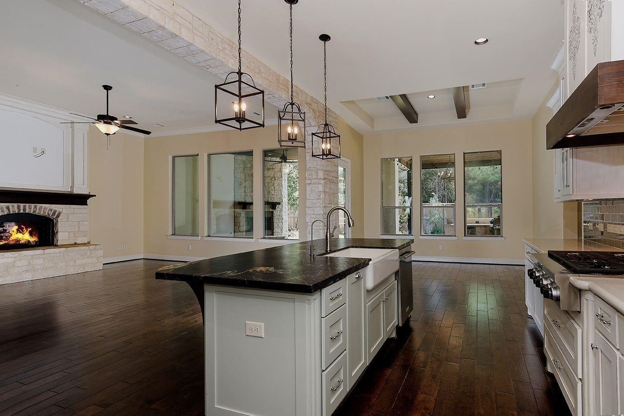 330 Mill Creek Road Pinehurst, TX 77362 - Photo 10 of 36 a kitchen with stainless steel appliances granite countertop a sink a stove and a wooden floors