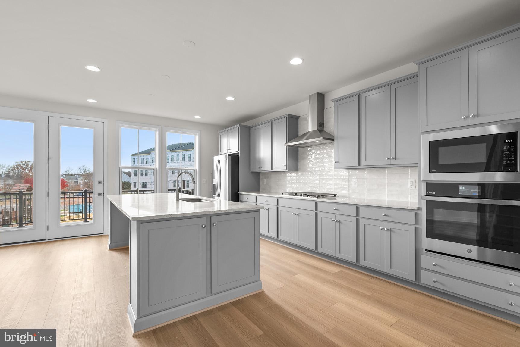 43423 Farringdon Square Ashburn, VA 20148 - Photo 11 of 31 a kitchen with stainless steel appliances granite countertop a stove and a sink