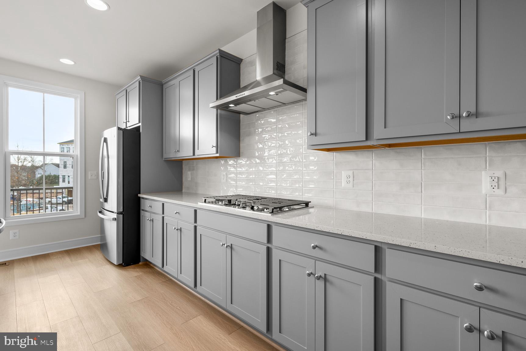 43423 Farringdon Square Ashburn, VA 20148 - Photo 13 of 31 a kitchen with stainless steel appliances granite countertop a refrigerator a sink dishwasher a stove and white countertops with cabinets