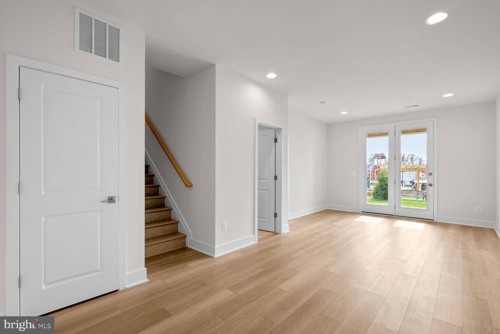 43423 Farringdon Square Ashburn, VA 20148 - Photo 2 of 31 a view of an empty room with wooden floor and entryway