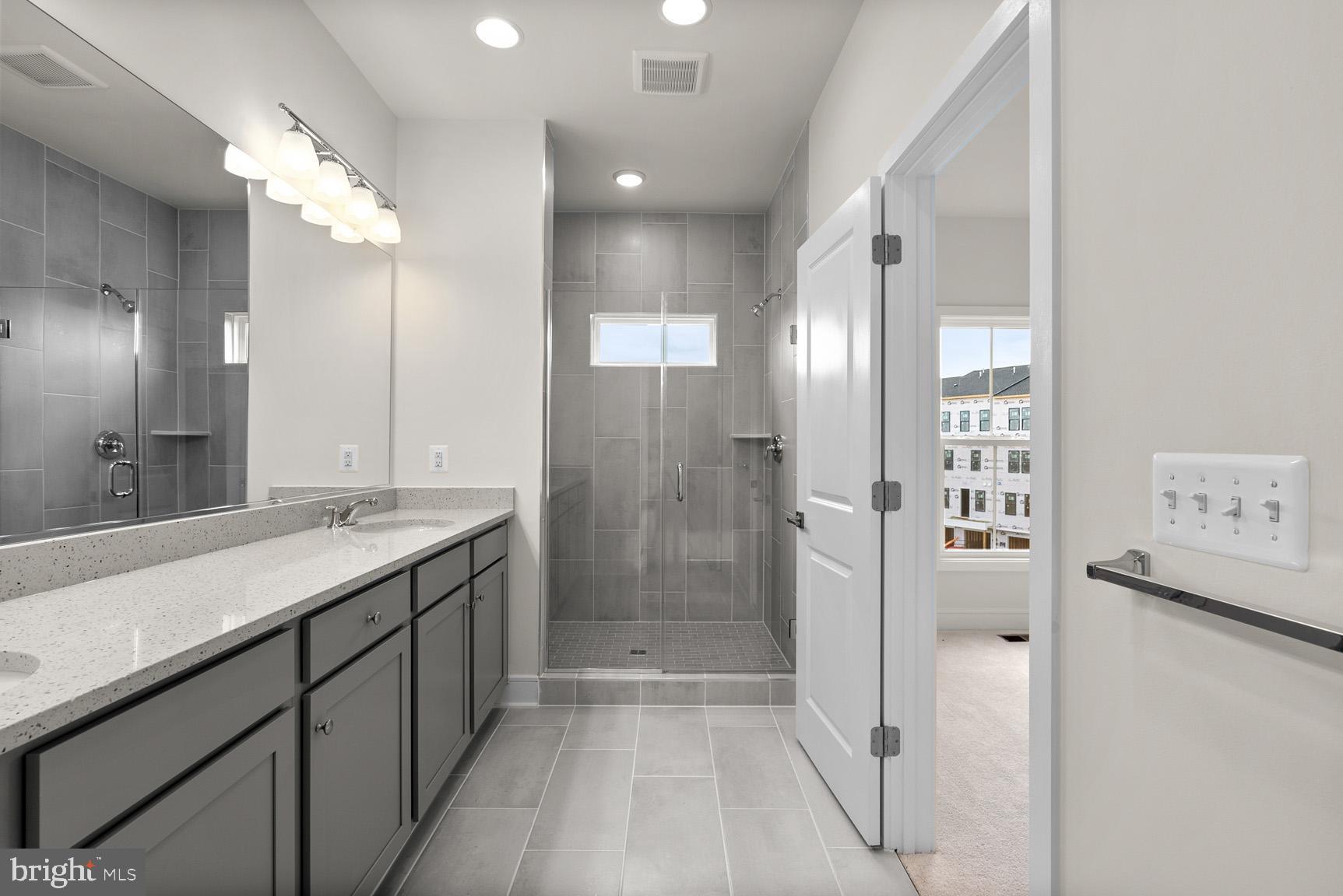 43423 Farringdon Square Ashburn, VA 20148 - Photo 21 of 31 a bathroom with a double vanity sink mirror and shower