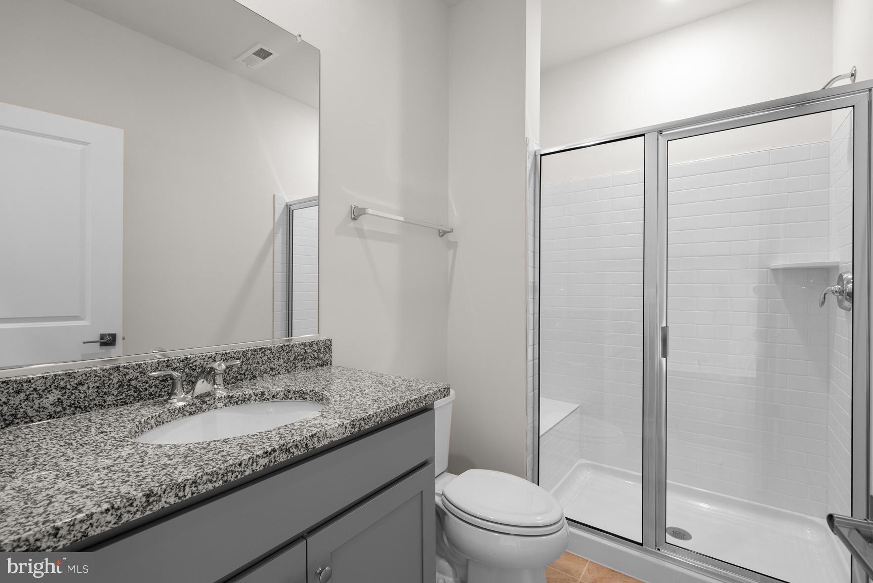 43423 Farringdon Square Ashburn, VA 20148 - Photo 4 of 31 a bathroom with a granite countertop sink toilet and shower