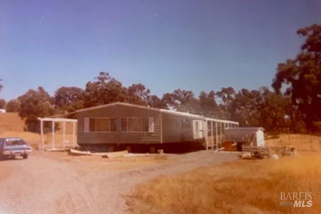 a view of a house with a snow in the yard