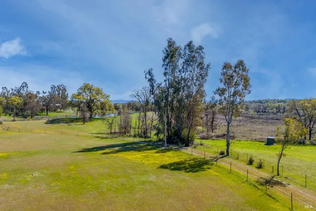a view of a swimming pool with an outdoor seating and a yard